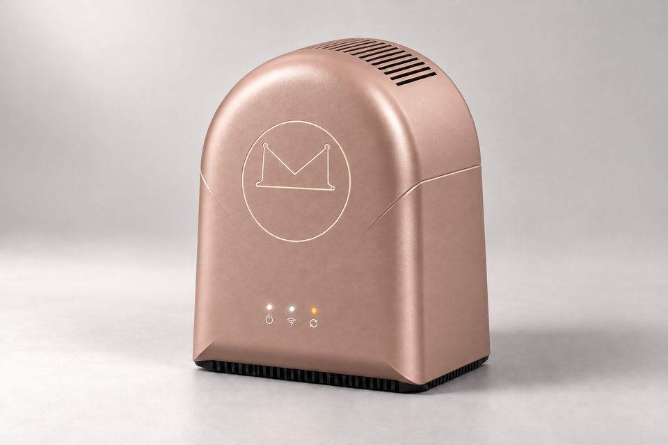 The Arch concept in Rose Gold: a warm, softly reflective rose gold, arch-shaped device on a pale grey backdrop, with vent slots across its curved top, a seam sweeping around its sides, a subtle tone-on-tone Synkurl mark in a circle, three status lights and a dark slatted base.