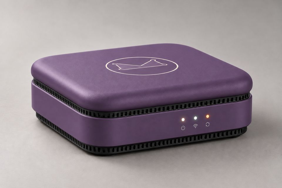 The Box concept in Dusk Violet: a low, square device with a softly rounded, muted purple lid bearing the outlined Synkurl mark. Black vent slots run above and below the violet front band, which shows three glowing status lights.